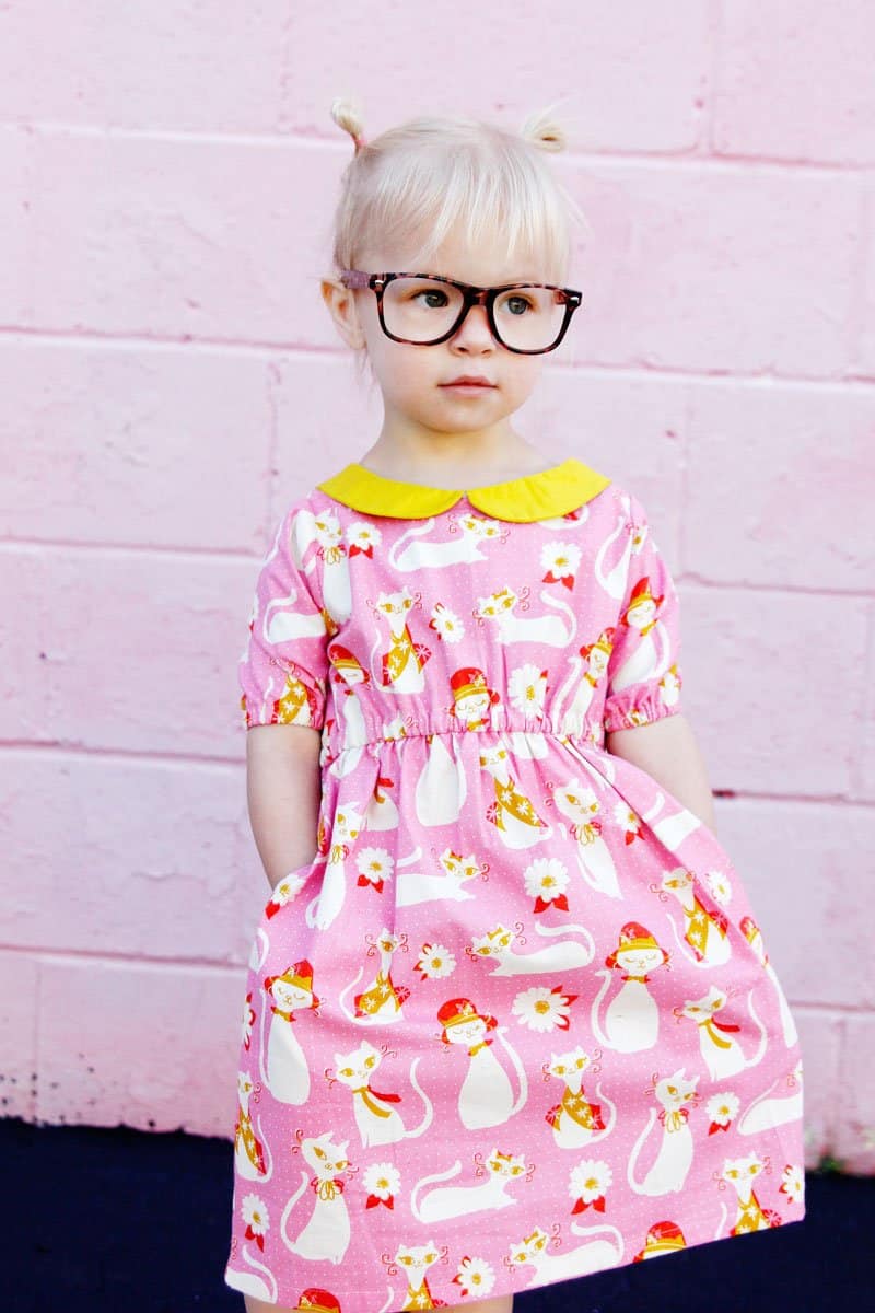 The Olivia Dress sewing up in gorgeous quilting cotton with a bright yellow collar to match! Simple lines with a few really cute features! Simple to get on your kiddo, the waistline is elastic and it just slips right on! Plus...Pockets! || See Kate Sew #dresspatterns #kidsfashion #dresses #seekatesew
