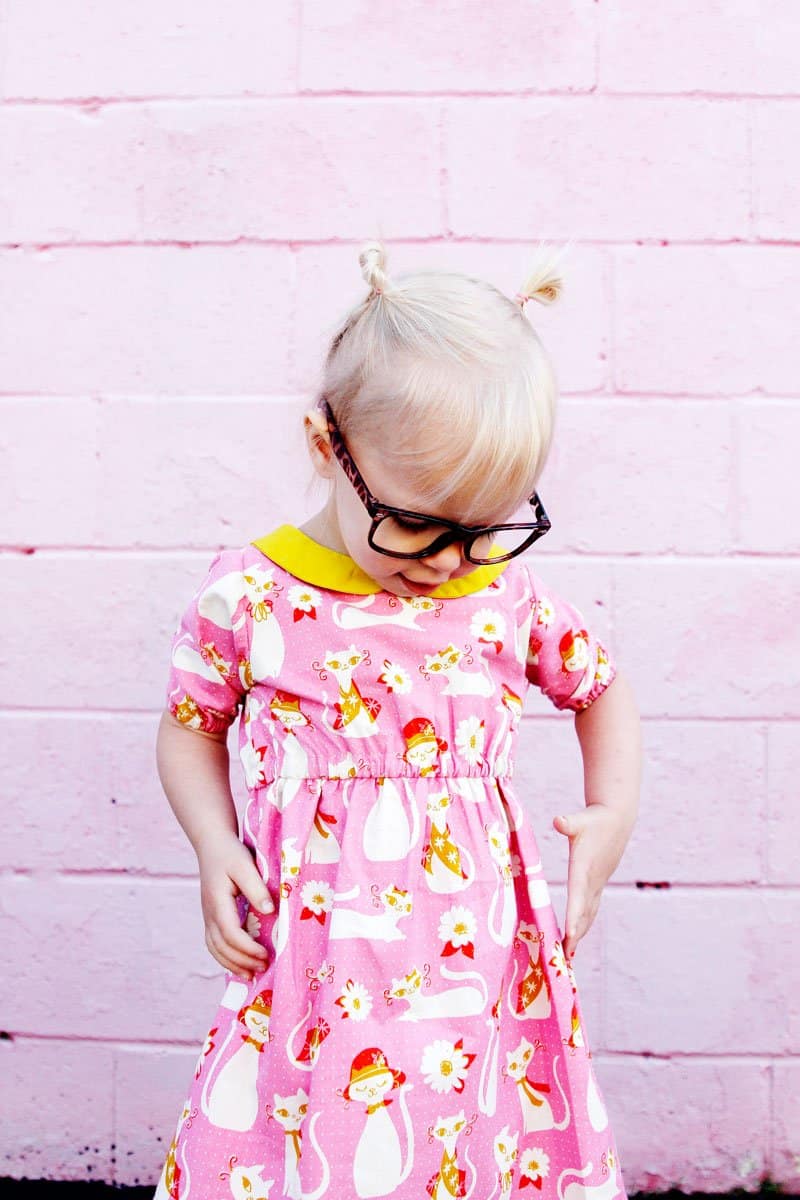 The Olivia Dress sewing up in gorgeous quilting cotton with a bright yellow collar to match! Simple lines with a few really cute features! Simple to get on your kiddo, the waistline is elastic and it just slips right on! Plus...Pockets! || See Kate Sew #dresspatterns #kidsfashion #dresses #seekatesew