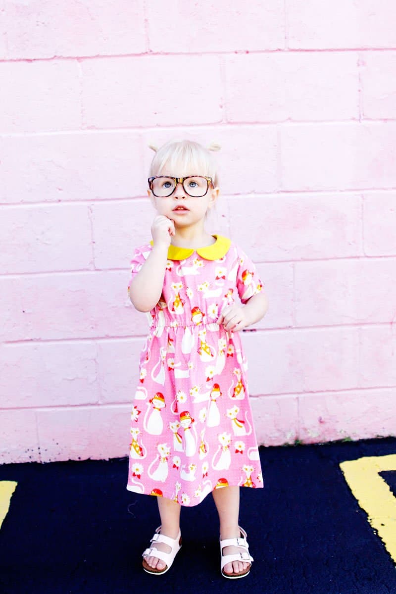 The Olivia Dress sewing up in gorgeous quilting cotton with a bright yellow collar to match! Simple lines with a few really cute features! Simple to get on your kiddo, the waistline is elastic and it just slips right on! Plus...Pockets! || See Kate Sew #dresspatterns #kidsfashion #dresses #seekatesew