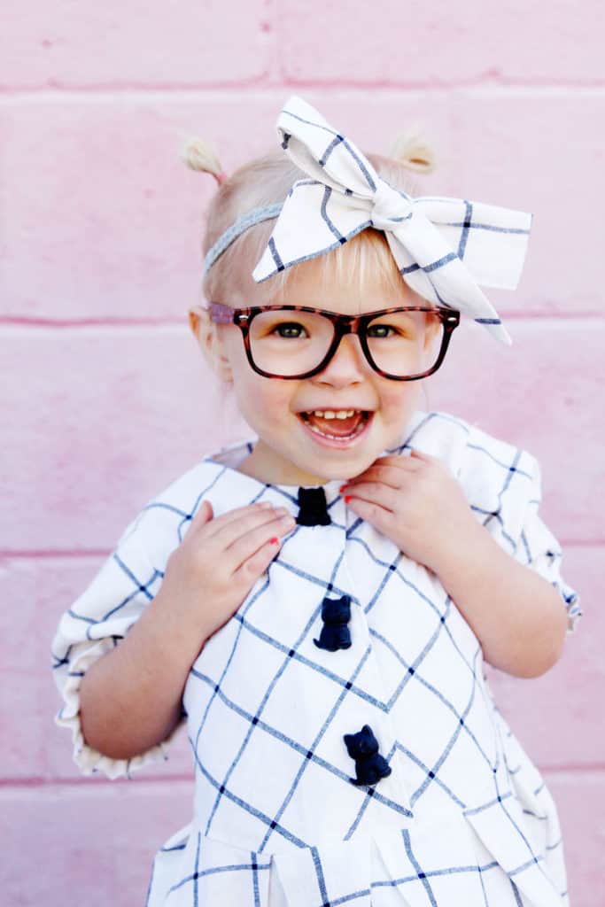 Zig Zag Dress pattern gives a preppy look with it's plaid and pleats! It's curved bodice gives it a really cute swing! Elastic sleeves, big buttons, and facing on the inside makes this dress a dress to love! || See Kate Sew #dresspatterns #kidsfashion #dresses #seekatesew
