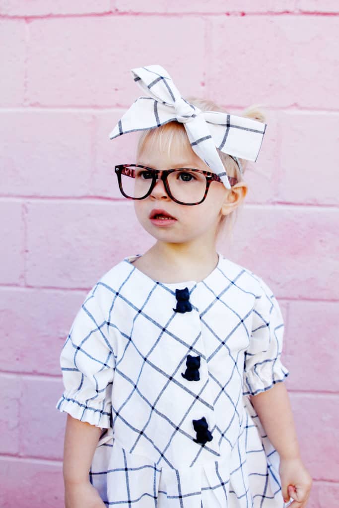 Zig Zag Dress pattern gives a preppy look with it's plaid and pleats! It's curved bodice gives it a really cute swing! Elastic sleeves, big buttons, and facing on the inside makes this dress a dress to love! || See Kate Sew #dresspatterns #kidsfashion #dresses #seekatesew