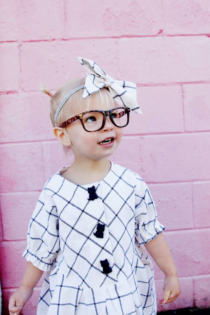 Zig Zag Dress pattern gives a preppy look with it's plaid and pleats! It's curved bodice gives it a really cute swing! Elastic sleeves, big buttons, and facing on the inside makes this dress a dress to love! || See Kate Sew #dresspatterns #kidsfashion #dresses #seekatesew