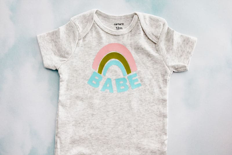 Make this easy Rainbow Baby Onesie with a blank onesie and this free SVG file. Choose a cute onesie with 3 colors of iron-on vinyl and you have a perfect gift for a sweet rainbow baby or your own sweet rainbow babe! || See Kate Sew #rainbowbaby #babyonesies #cricutprojects #freesvg #seekatesew