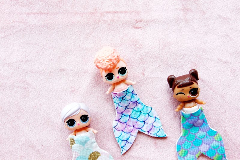 Summertime is for MERMAIDS! This is a super fun craft that is perfect for a summer afternoon! These mermaid tails for dolls are faux leather glued together so they are very fast so your kids can get right to playing! || See Kate Sew #mermaidtails #mermaidcraft #loldollaccessories #dollaccessories #seekatesew