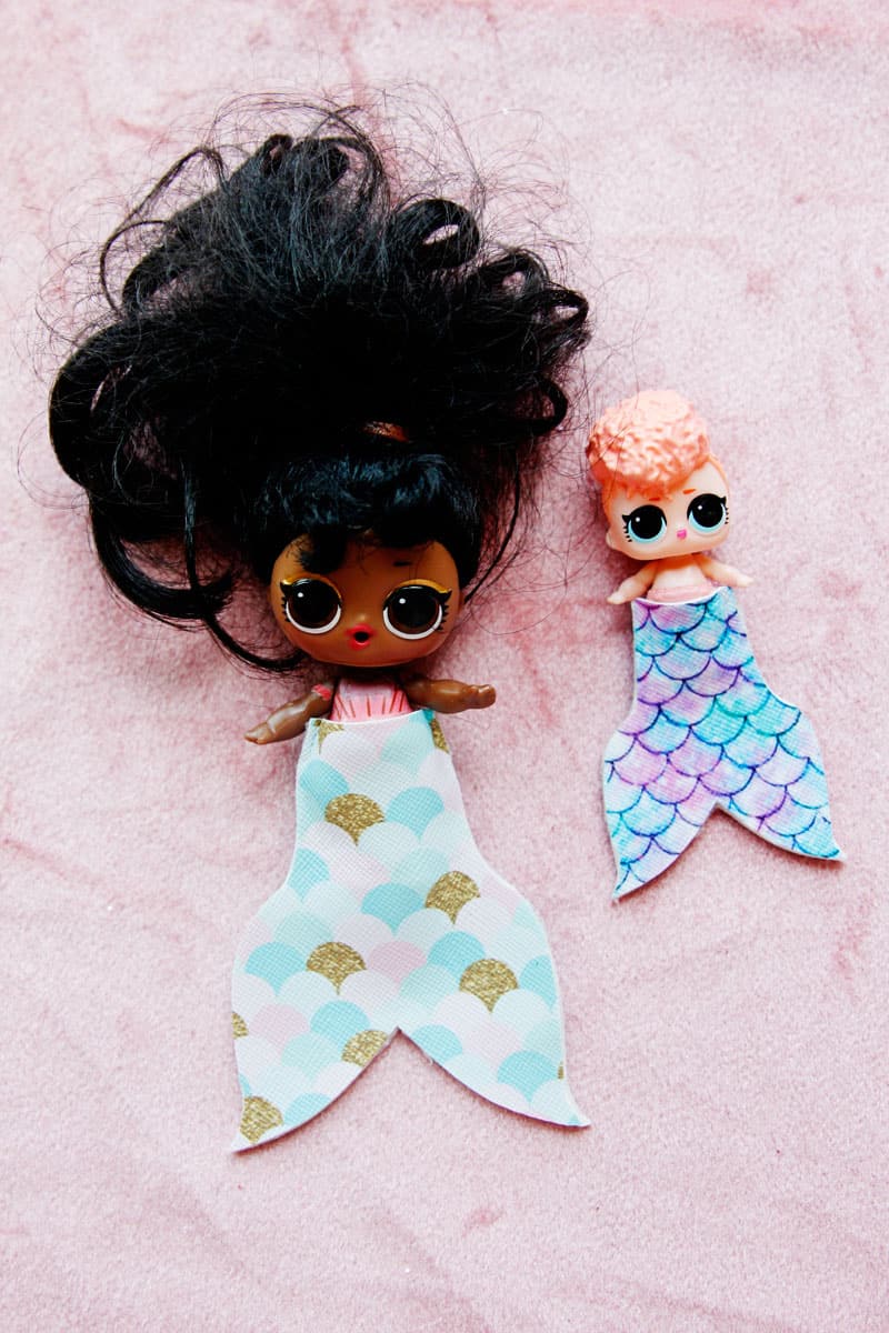 Summertime is for MERMAIDS! This is a super fun craft that is perfect for a summer afternoon! These mermaid tails for dolls are faux leather glued together so they are very fast so your kids can get right to playing! || See Kate Sew #mermaidtails #mermaidcraft #loldollaccessories #dollaccessories #seekatesew