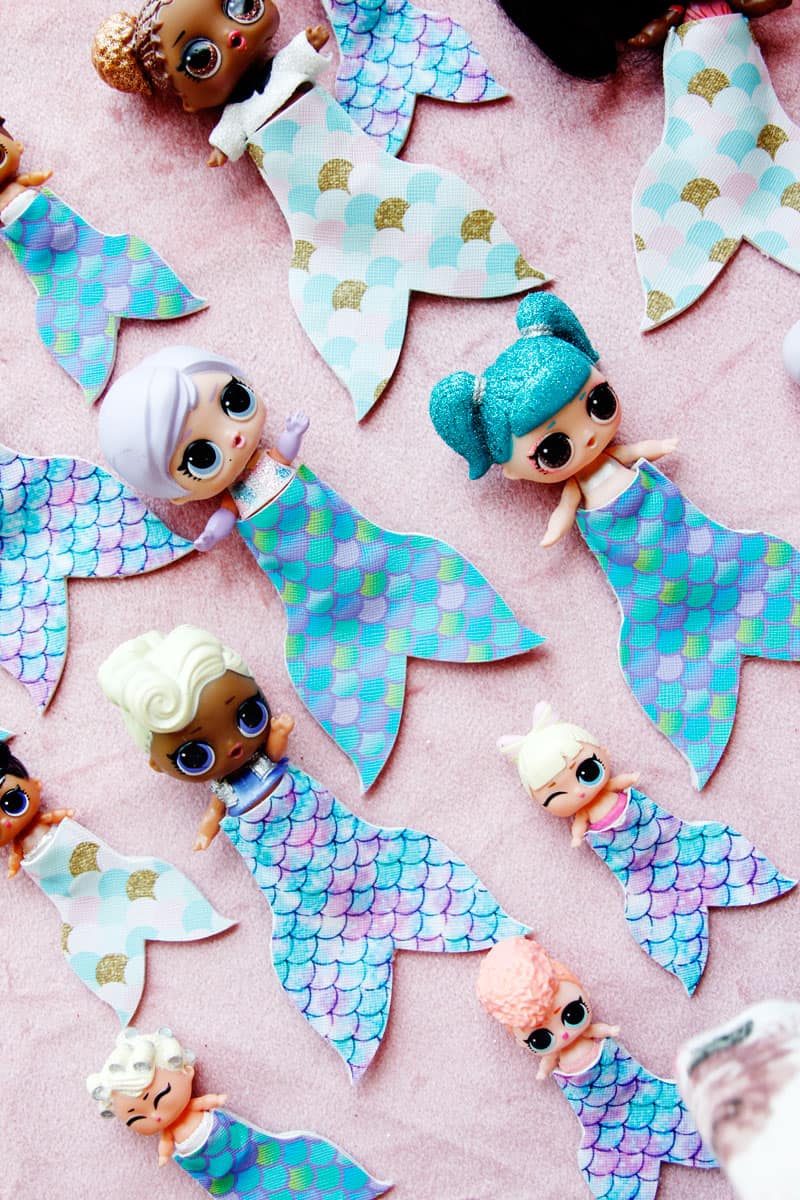 Summertime is for MERMAIDS! This is a super fun craft that is perfect for a summer afternoon! These mermaid tails for dolls are faux leather glued together so they are very fast so your kids can get right to playing! || See Kate Sew #mermaidtails #mermaidcraft #loldollaccessories #dollaccessories #seekatesew