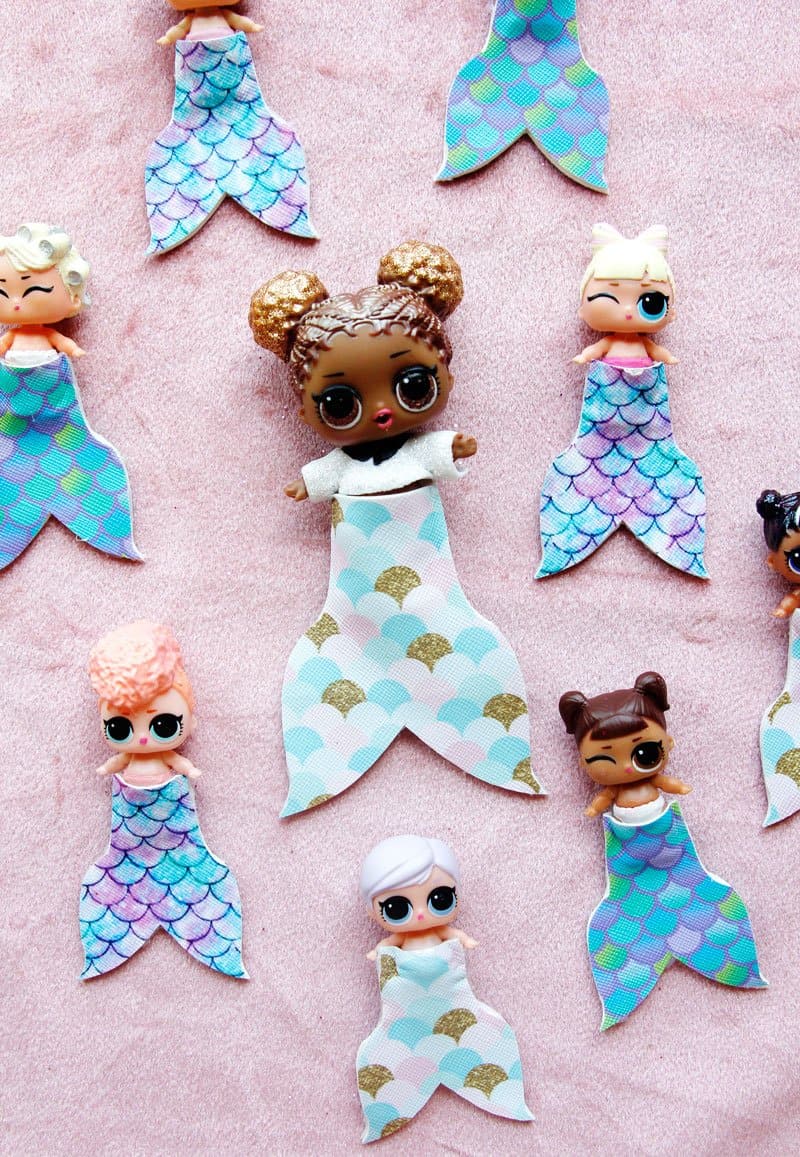 Summertime is for MERMAIDS! This is a super fun craft that is perfect for a summer afternoon! These mermaid tails for dolls are faux leather glued together so they are very fast so your kids can get right to playing! || See Kate Sew #mermaidtails #mermaidcraft #loldollaccessories #dollaccessories #seekatesew