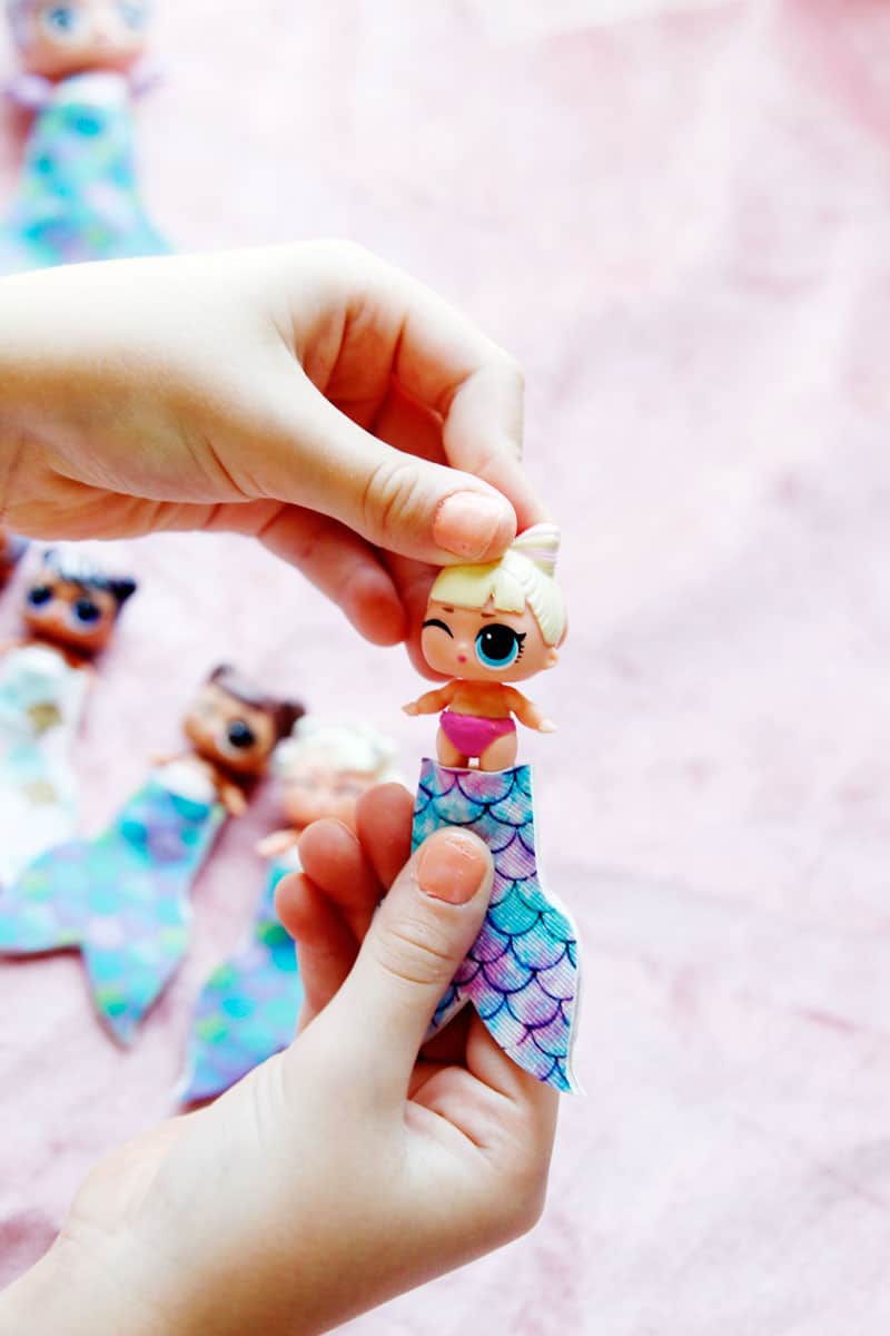 Summertime is for MERMAIDS! This is a super fun craft that is perfect for a summer afternoon! These mermaid tails for dolls are faux leather glued together so they are very fast so your kids can get right to playing! || See Kate Sew #mermaidtails #mermaidcraft #loldollaccessories #dollaccessories #seekatesew