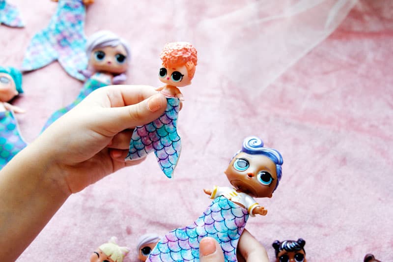 Summertime is for MERMAIDS! This is a super fun craft that is perfect for a summer afternoon! These mermaid tails for dolls are faux leather glued together so they are very fast so your kids can get right to playing! || See Kate Sew #mermaidtails #mermaidcraft #loldollaccessories #dollaccessories #seekatesew