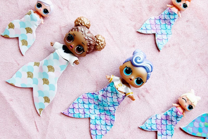 Summertime is for MERMAIDS! This is a super fun craft that is perfect for a summer afternoon! These mermaid tails for dolls are faux leather glued together so they are very fast so your kids can get right to playing! || See Kate Sew #mermaidtails #mermaidcraft #loldollaccessories #dollaccessories #seekatesew