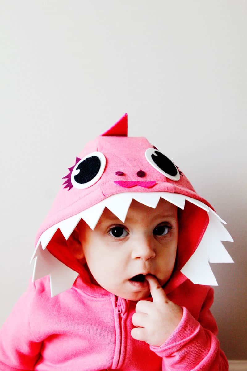 This Pink DIY Baby Shark Costume with a Hoodie is so easy to make! It's the perfect no-sew Halloween costume! || See Kate Sew #babyshark #diyhalloweencostume #babycostume #diycostume #easycostumes #seekatesew